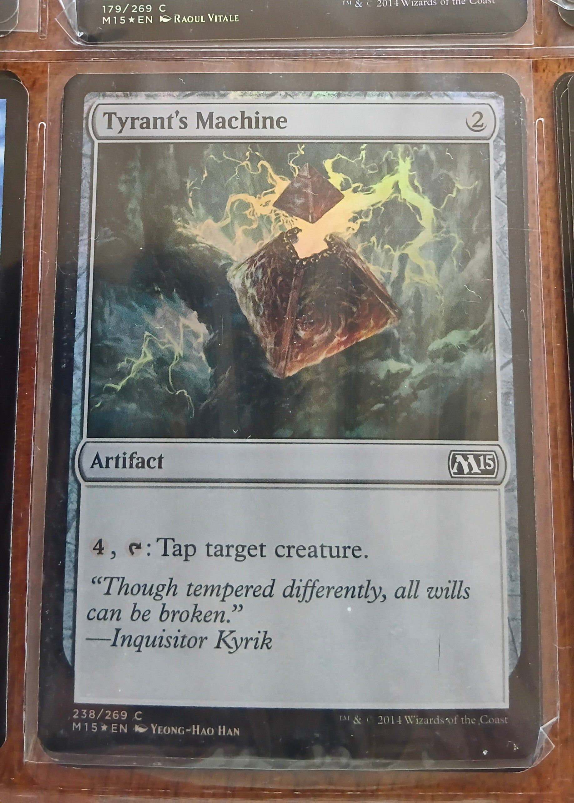 Trading card titled 'Tyrant's Machine' in a protective sleeve.