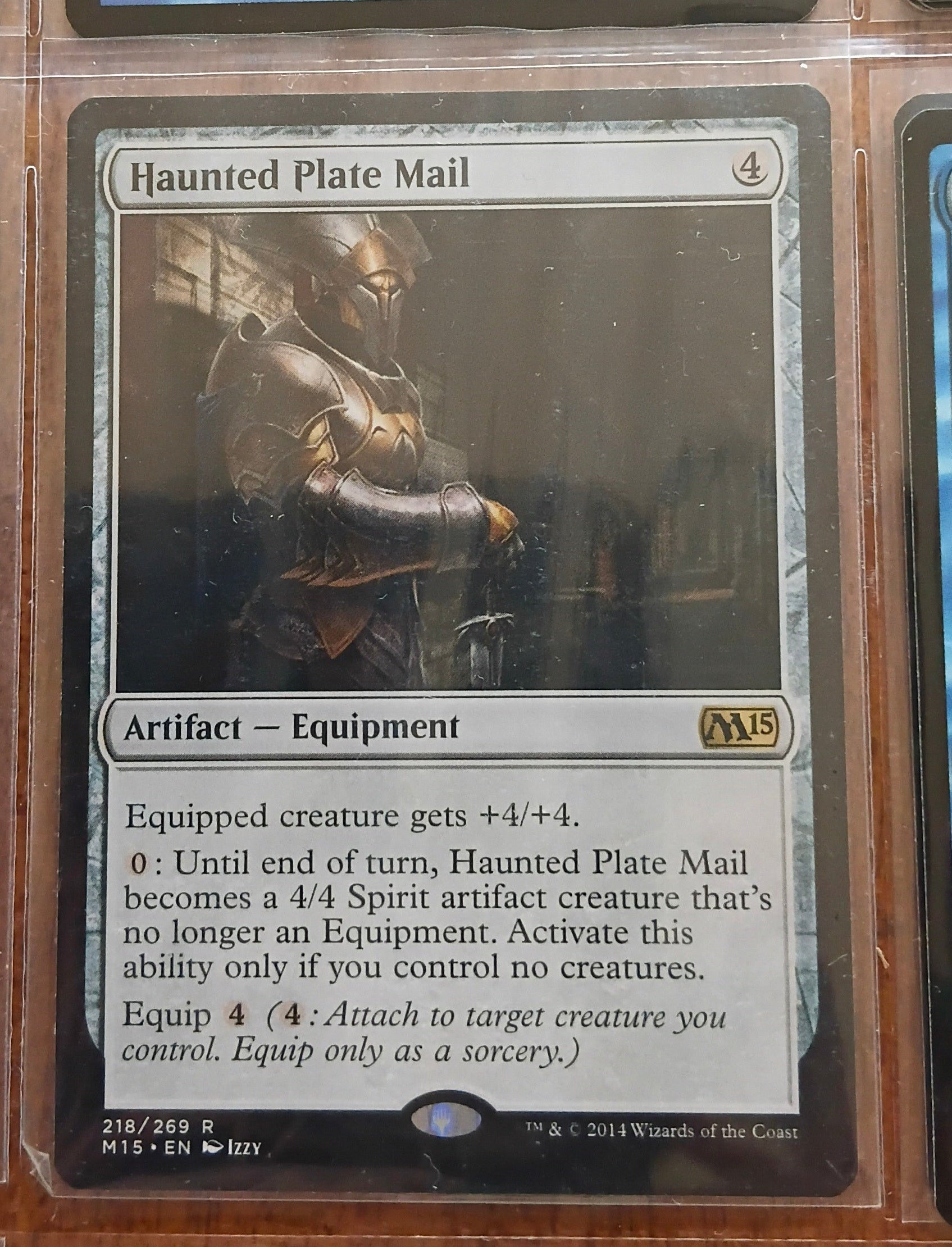 Trading card featuring 'Haunted Plate Mail' with a character in armor on a dark background.