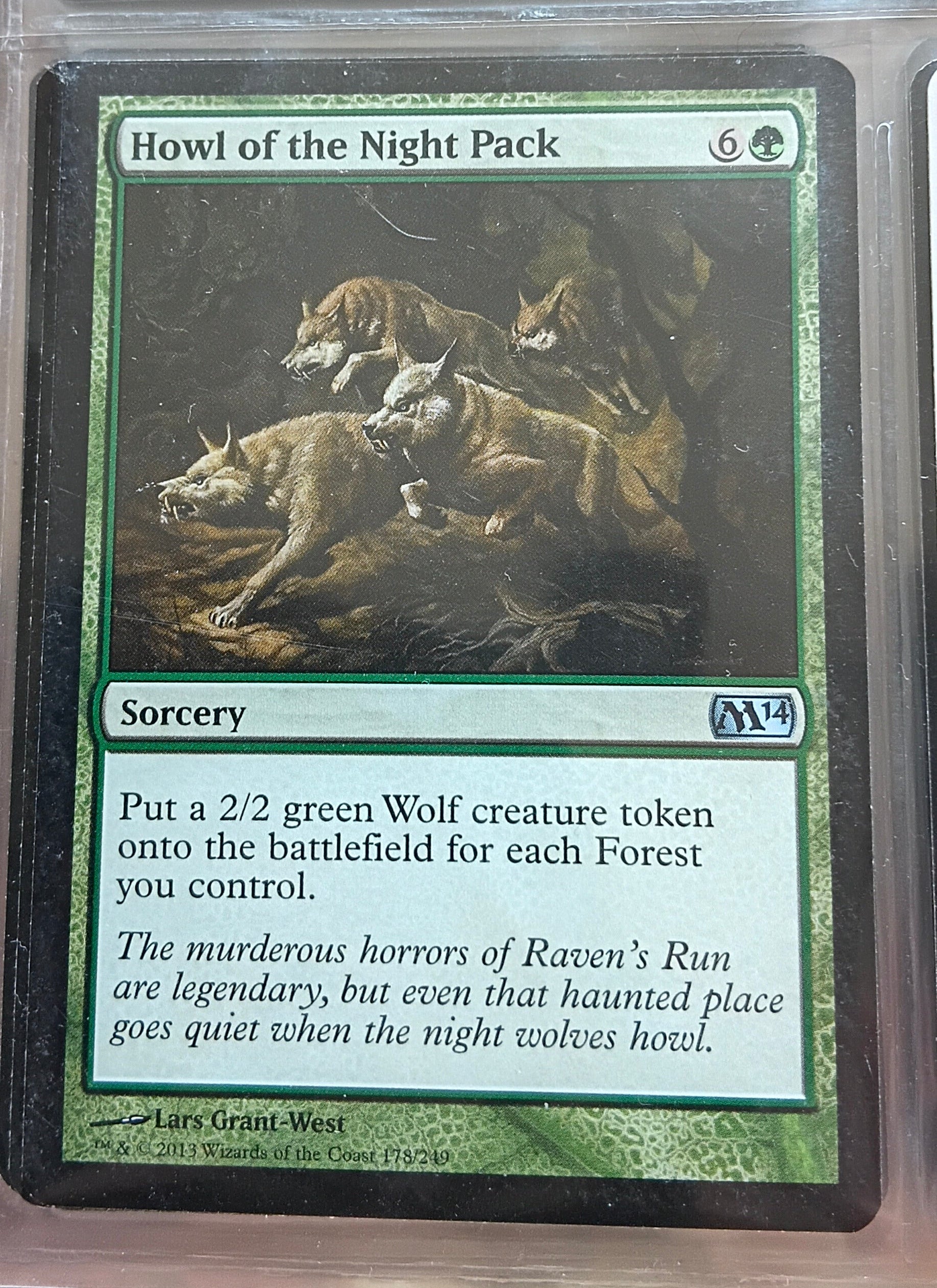 Trading card featuring a wolf in a protective stance on a green background